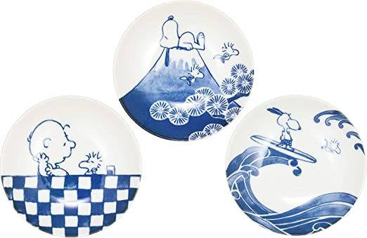 three blue and white plates with cartoon characters on them