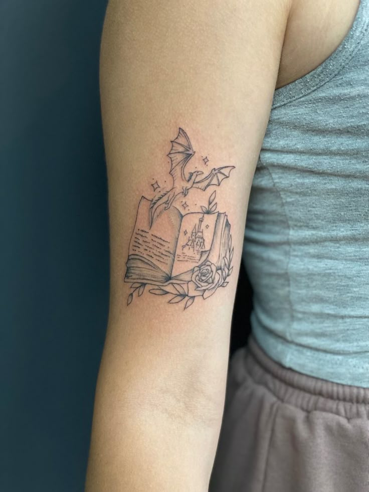 a woman with a book tattoo on her arm