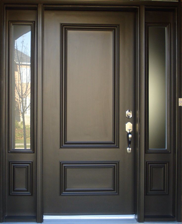 the front door is painted dark brown and has two glass panels on each side, with numbers etched into it