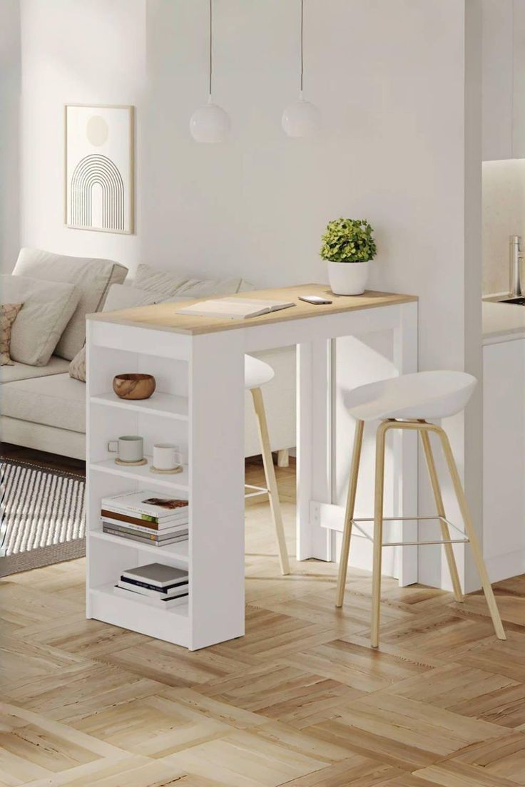 a white kitchen table with two stools next to it and a couch in the background