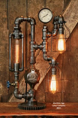 an old fashioned steam engine lamp with two lamps on it and a clock mounted to the wall