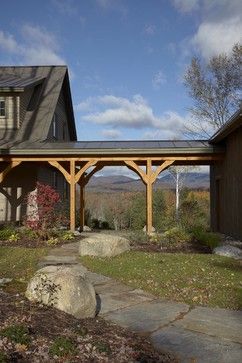 a house with a covered patio and stone walkway