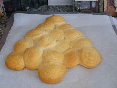 a bunch of bread rolls sitting on top of a white piece of paper next to a window