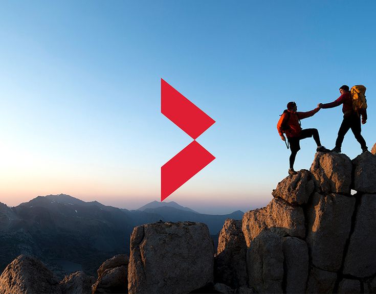 two people holding hands on top of a mountain with an arrow pointing to each other