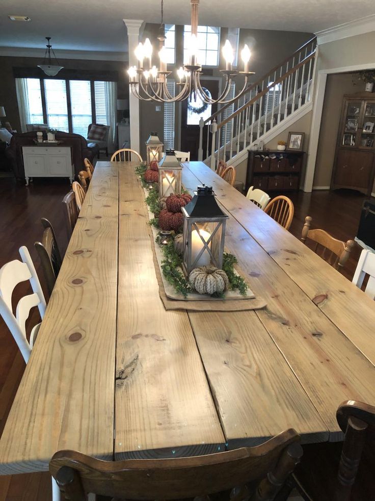 a long wooden table with candles on it