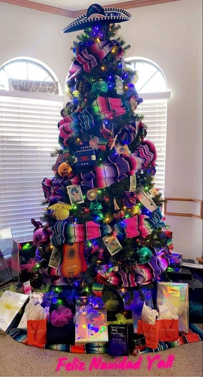 a brightly colored christmas tree with lots of presents on it's bottom and sides