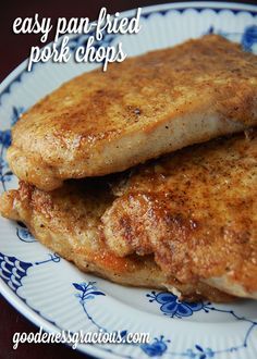 two pieces of fried pork chops on a blue and white plate with the words easy pan fried pork chops