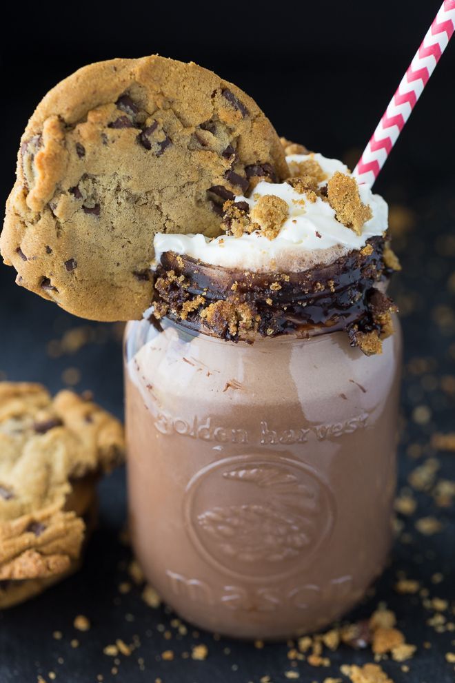 an ice cream sundae in a mason jar with a cookie on top