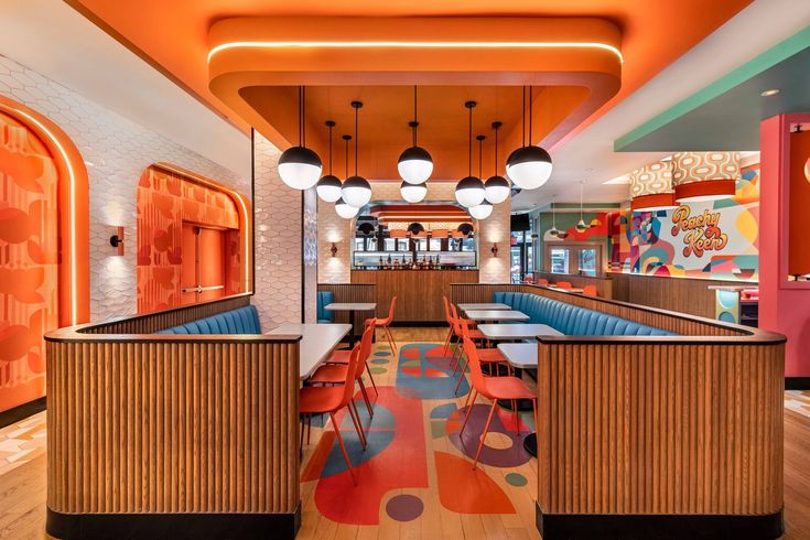 the inside of a restaurant with brightly colored booths