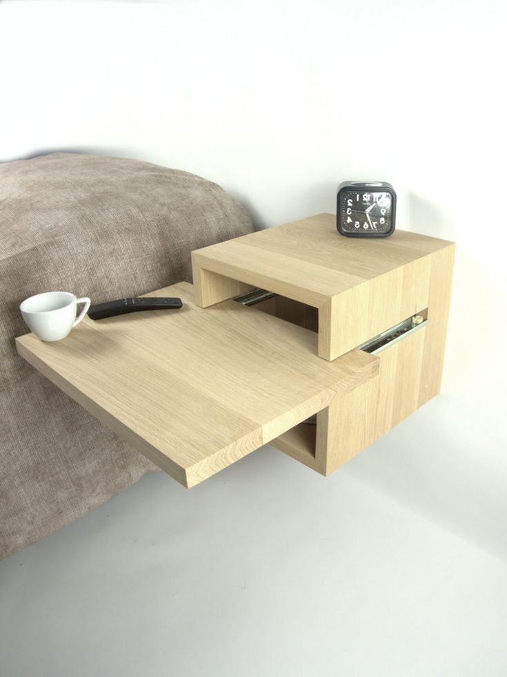 a wooden table with two drawers and a coffee cup on it