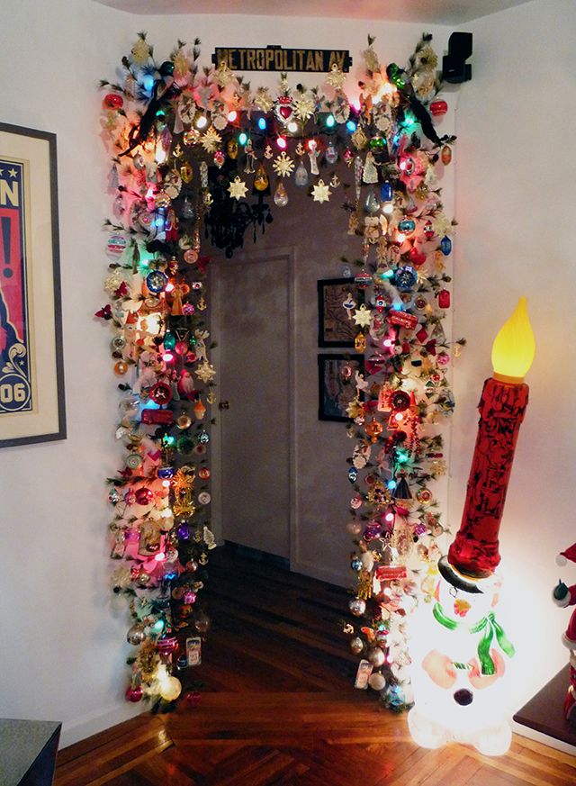 a doorway decorated with christmas lights and decorations