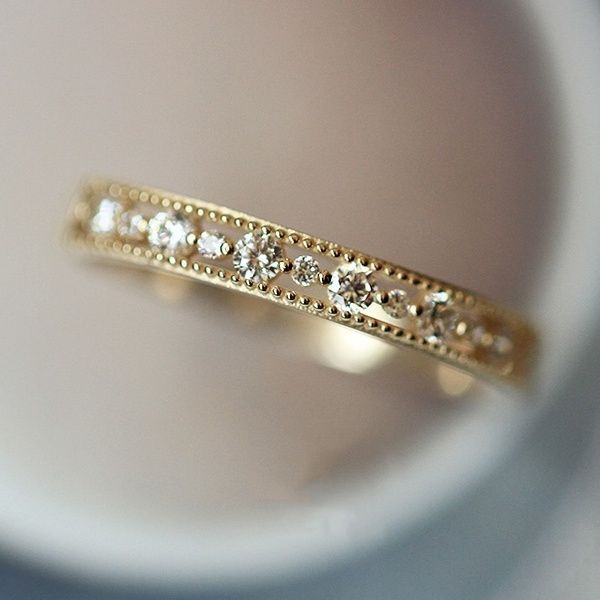 a close up view of a gold ring with diamonds