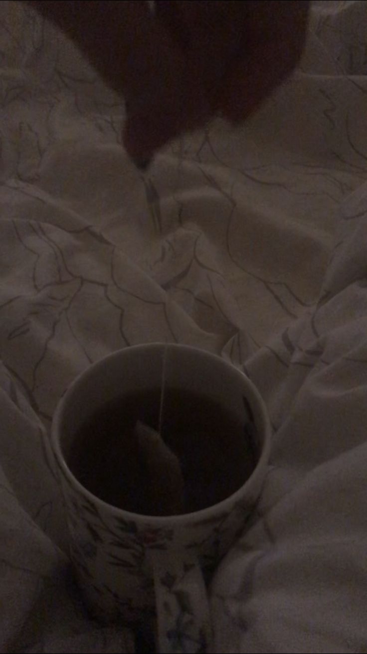 someone is pouring something into a cup on the bed