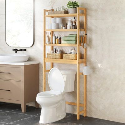 a bathroom with a toilet, sink and shelving unit next to a mirror on the wall