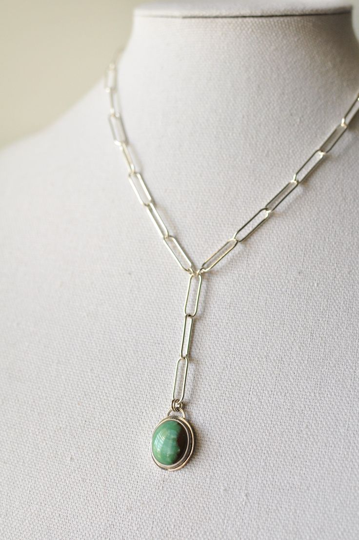 Delightful muted blue/green Hubei turquoise semiprecious gemstone reminds me of waves crashing onto the beach. This delicate oval is set in a simple handcrafted polished bright sterling silver setting and hangs from a large link sterling silver Y chain. Necklace is approximately 17"L with a 2"L drop of 3 links Pendant measures approximately 1"L x 5/8"W Large spring ring clasp .925 Sterling Silver Modern Turquoise Sterling Silver Jewelry, Sterling Silver Lariat Jewelry With Natural Stones, Minimalist Oval Jewelry With Silver Chain, Modern Oval Turquoise Jewelry, Modern Turquoise Oval Jewelry, Minimalist Oval Silver Chain Jewelry, Turquoise Sterling Silver Long Drop Jewelry, Sterling Silver Turquoise Necklace With Adjustable Chain, Turquoise Necklace With Natural Stones In Sterling Silver