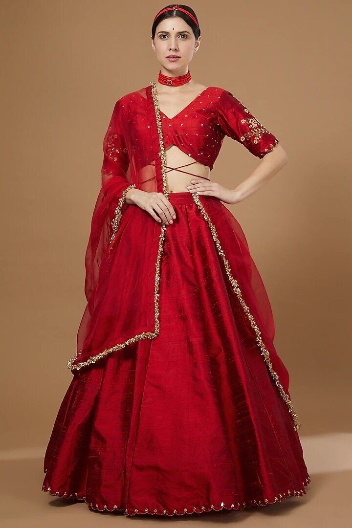 Red Embroidered Lehenga Set Featuring a red lehenga in raw silk base with hand embroidery. It is paired with a matching hand embroidered blouse and an organza dupatta. This product will be shipped to you after 1-2 weeks from the date of order placed. All custom made orders are not returnable. Pls contact for Size chart and for other more colors Request You :To provide contact details for courier services. {VARIATION MAY COME DEPENDING UPON AVALIBILITY OF LACES OR GOTTA PATI} NOTE:  1) Visual Samples on website may differ slightly from actual product due to light & effects during photography (Length & Breadth have 1 n 1.5 inches  +/-). 2) Before placing order ,pls confirm product n color availability on +91 7903893945 & +91 8447750028(WhatsApp) 3) For Wholesale Order MOQ is 5 Pieces of any Red Raw Silk Anarkali Set For Navratri, Red Raw Silk Traditional Wear With Sheer Dupatta, Red Tissue Silk Traditional Wear With Dupatta, Red Organza Floor-length Saree, Floor-length Red Organza Saree, Red Floor-length Raw Silk Anarkali Set, Festive Red Sets With Dori Work, Red Tissue Silk Traditional Wear For Eid, Red Anarkali Choli In Chanderi Fabric