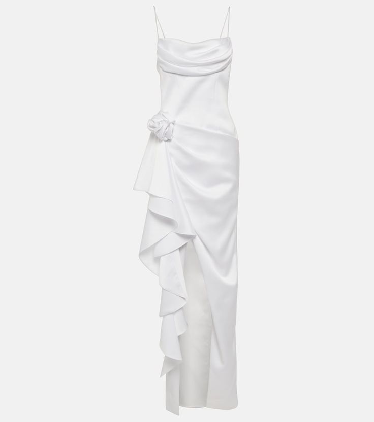 a white dress with ruffles on the bottom and one shoulder, asymmetrically draped over it