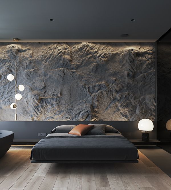 a large bed sitting in a bedroom next to a wall mounted stone art piece on the wall