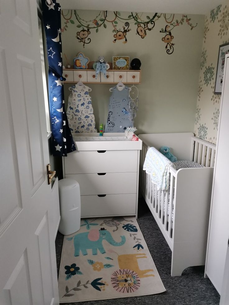 a baby's room with a crib, dresser and changing table in it