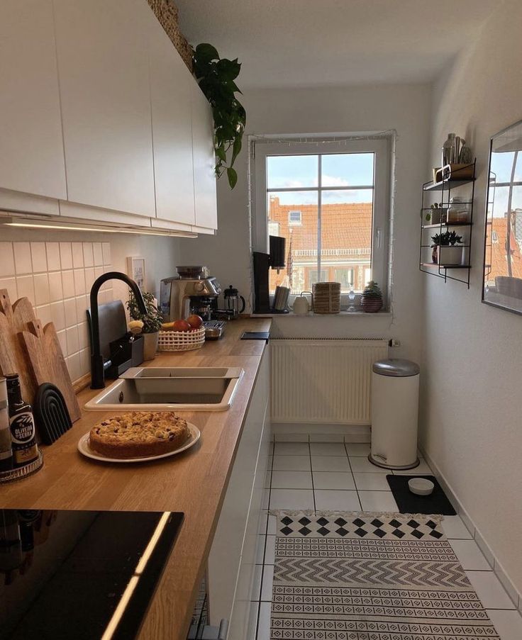 a kitchen with a stove top oven sitting next to a window