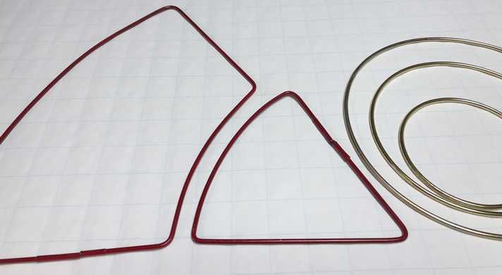 a pair of scissors and wire sitting on top of a sheet of paper next to each other