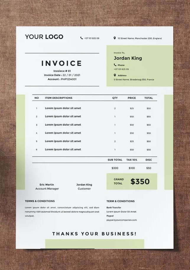 a green and white invoice on top of a wooden table