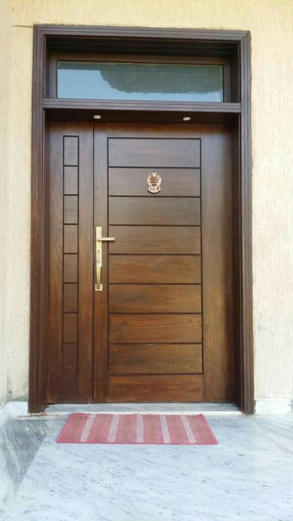 a wooden door with a red rug in front of it