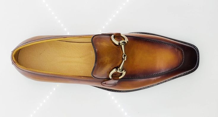 Style: 509-28-Cognac Elegant Burnished Calfskin slip-on Loafer from the Carrucci collection features a Double Gore for your perfect fit, soft Calfskin lining, Horsebit Hardware detailing, and a clean welt! Elegant Brown Slip-ons For Work, Elegant Cognac Loafers With Plain Toe, Elegant Cognac Slip-on Moccasins, Elegant Cognac Moc Toe Loafers, Elegant Cognac Loafers For Business Casual, Elegant Brown Slip-ons For Workwear, Elegant Brown Slip-ons For Office, Cognac Leather Sole Slip-on Loafers, Elegant Loafers With Leather Sole In Cognac