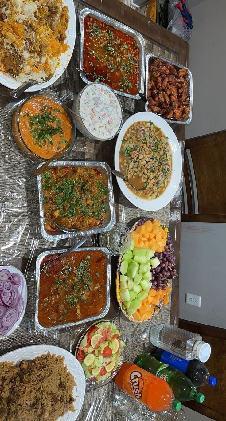 a table filled with lots of different types of food on top of plastic wrappers