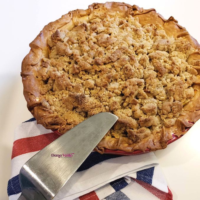 a pie sitting on top of a red white and blue cloth next to a knife