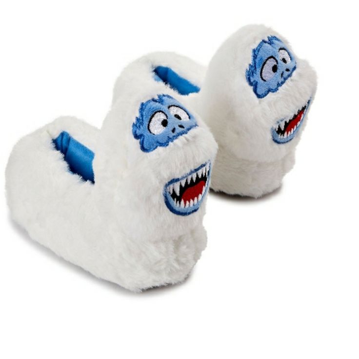 a pair of white slippers with blue eyes and mouthy teeth on the bottom