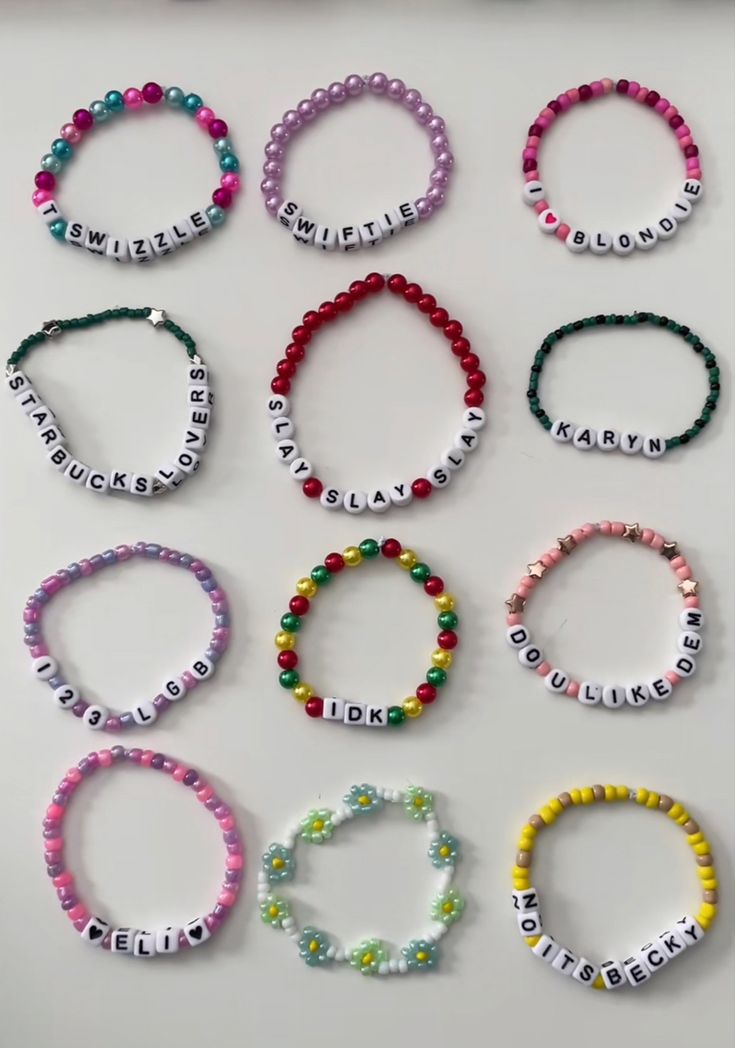 a bunch of bracelets that are made out of beads and some words on them