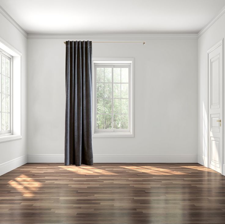 an empty room with wood floors and white walls