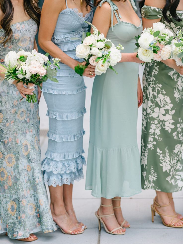 four bridesmaids pose for a photo in their dresses