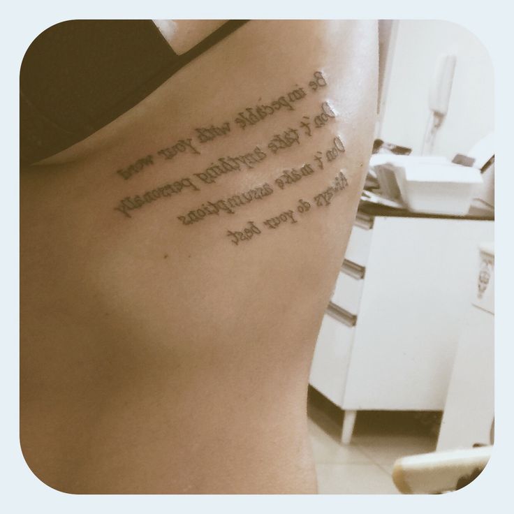 a woman with a tattoo on her back has words written in cursive writing