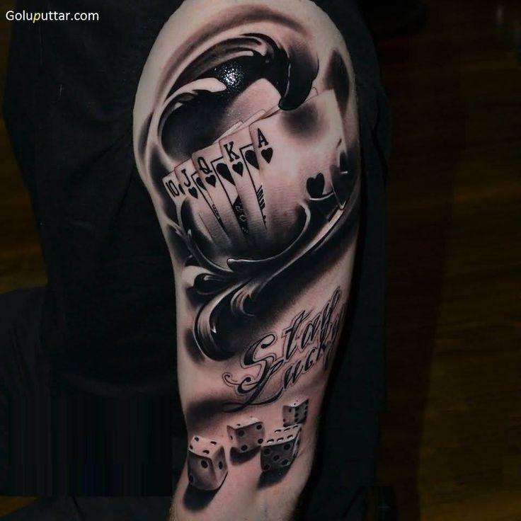 a man's arm with tattoos on it and some dice in the middle of his arm