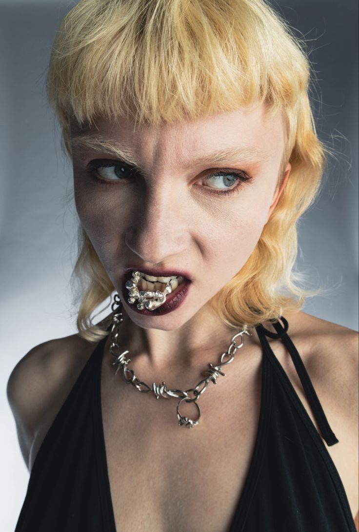 a woman with chains around her neck and mouth