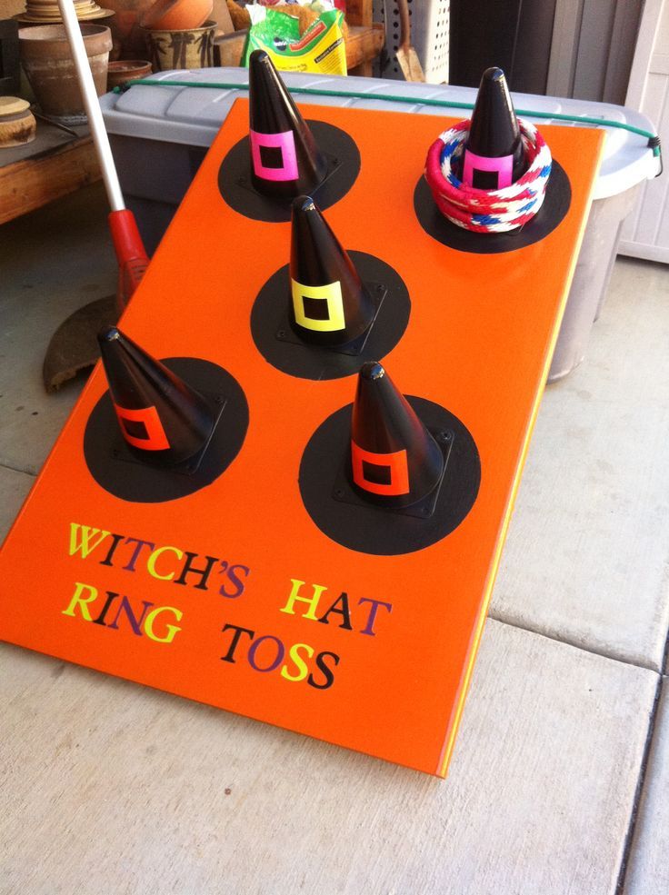 an orange sign that says witch hat ring toss on top of some sort of cones