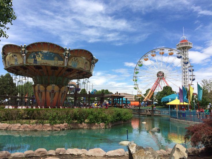 an amusement park with a ferris wheel in the background