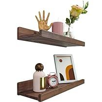 two wooden shelves with flowers and pictures on them