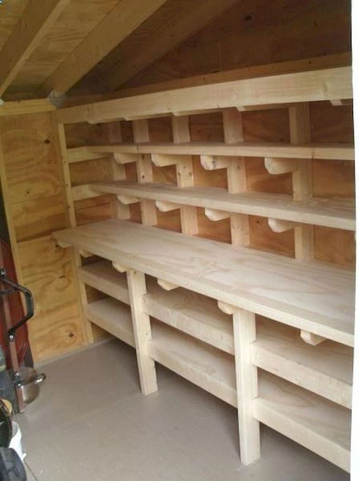 the inside of a storage room with wooden shelves