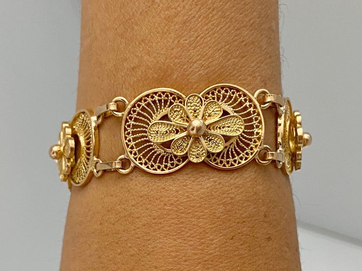 "Pacific Jewelry Key West Presents, Vintage Filigree bracelet, circa 1960's. Beautiful and intrinsic lace design, super feminine and just beautiful to look at. This bracelet is a true testament to fine craftsmanship with pliable threats and curls in 14K Yellow gold. ✔ Antique filigree bracelet ✔ Gold Karat: 14K ✔ Authentic art deco metalwork ✔ Chain attached at closure for added safety. ✔ Circa 1960's ✔ Hypoallergenic ✔ Intrinsic lace design ✔ 7.0 inches long ✔ Closure: Hinged Clip **Please mess Vintage Gold Filigree Bracelet For Wedding, Vintage 14k Gold Bracelets For Gift, Adjustable 14k Gold Jewelry With Intricate Design, Heirloom Bracelets With Intricate Design For Formal Occasions, Heirloom Filigree Bracelets For Formal Occasions, Heirloom Filigree Bracelets For Anniversary, Vintage 14k Gold Bracelet With Intricate Design, Adjustable Yellow Gold Bracelet With Intricate Design, Victorian Yellow Gold Bracelet As A Gift