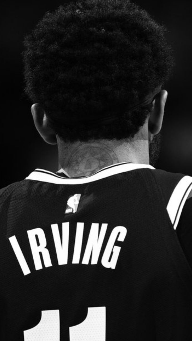 the back of a basketball player's jersey, with his hair in an afro