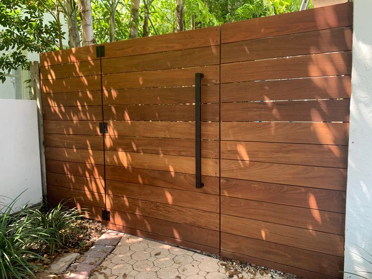 Custom hardwood IPE horizontal  gate Horizontal Modern Fence, Front Gate And Fence Ideas, Trellis Over Fence Gate, Wooden Horizontal Fence Gate, Horizontal Slat Privacy Fence, Side Fence With Gate, Mcm Fence Gate, Modern Wood Gate Entrance, Modern Wood Privacy Fence