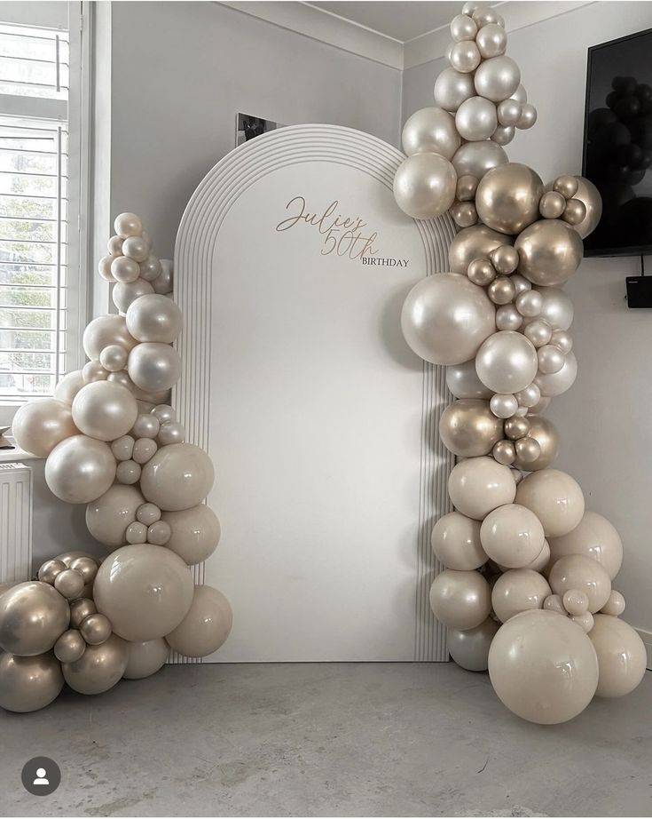 an arch made out of balloons in a room