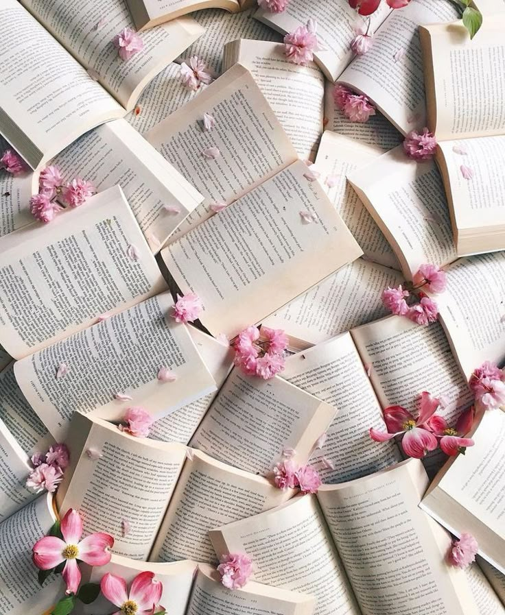 many open books with pink flowers on them