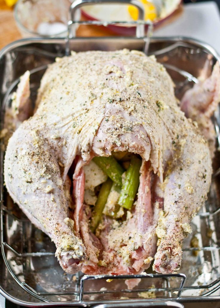 a whole chicken sitting on top of a metal pan