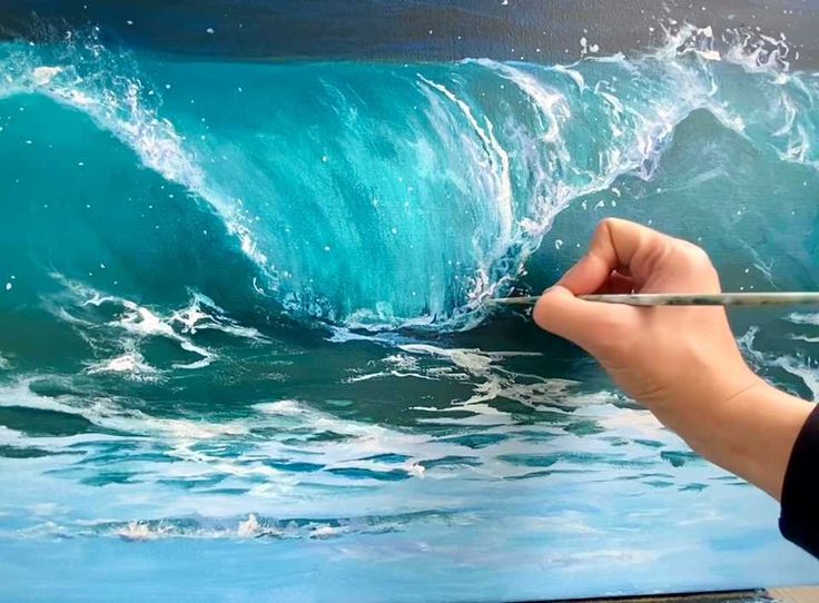 someone is painting a large wave in the ocean