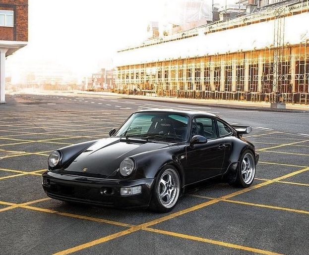 a black sports car parked in a parking lot