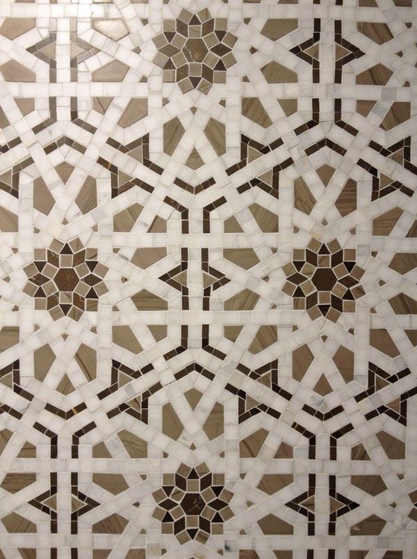 an intricately designed tile pattern in brown and white